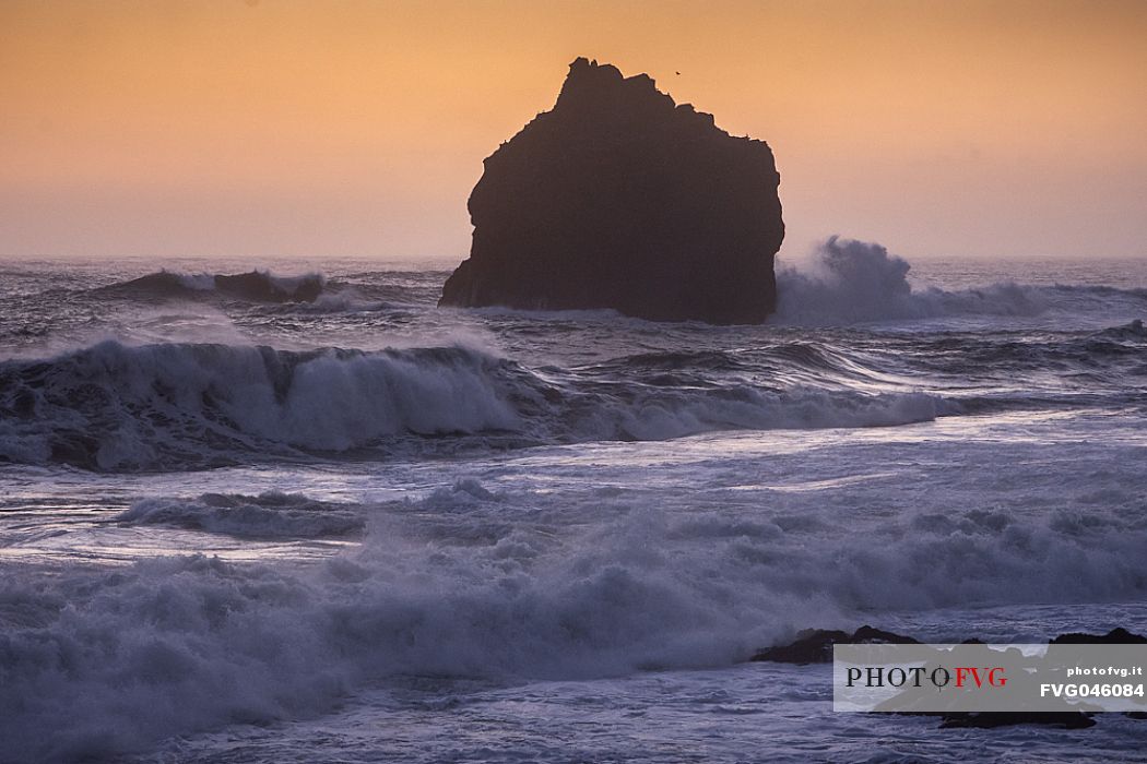 Lonely rock formation in the sea near the cliff of Valahnkur, Reykjanes peninsula, Iceland